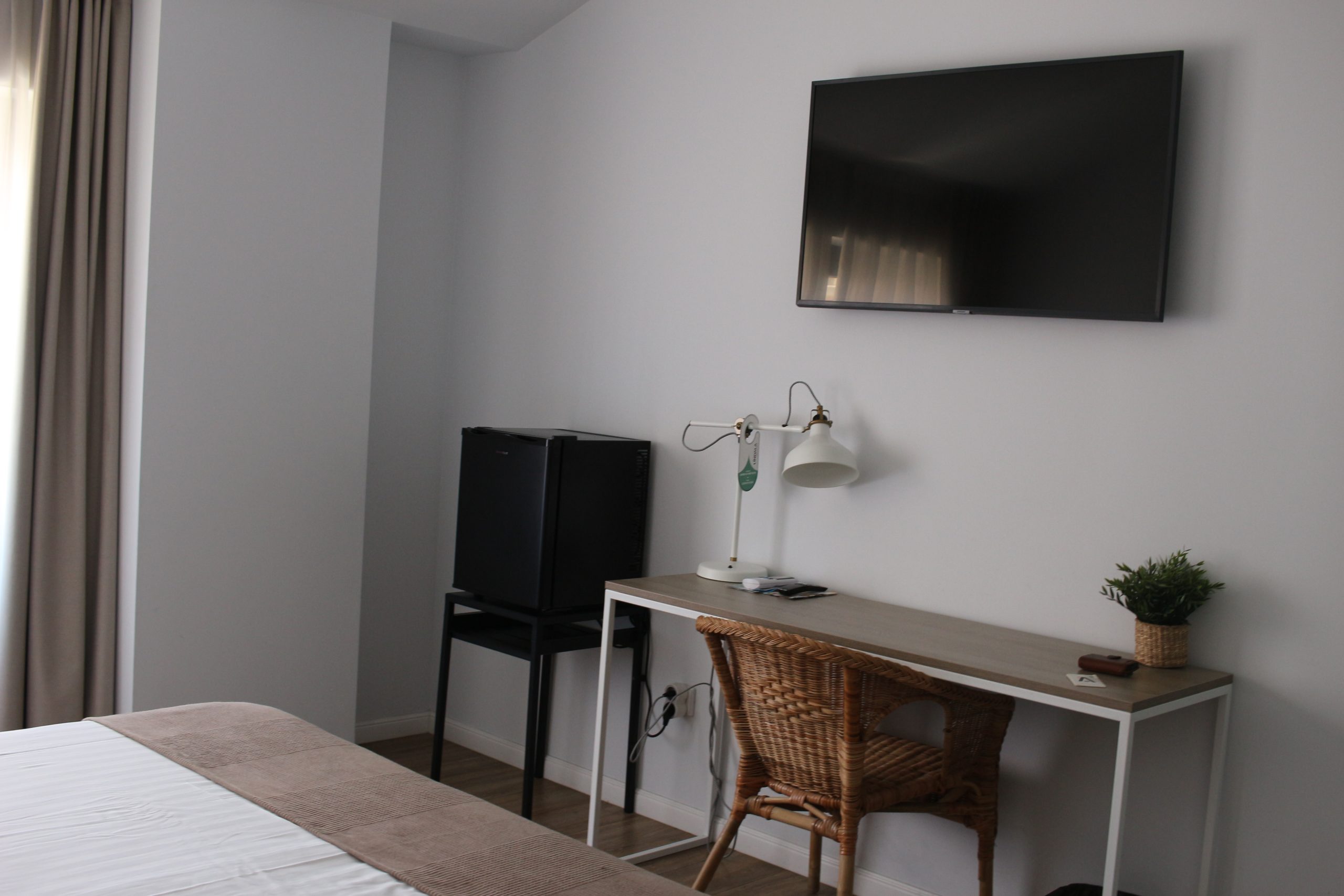 television, locker and table with chair in the room