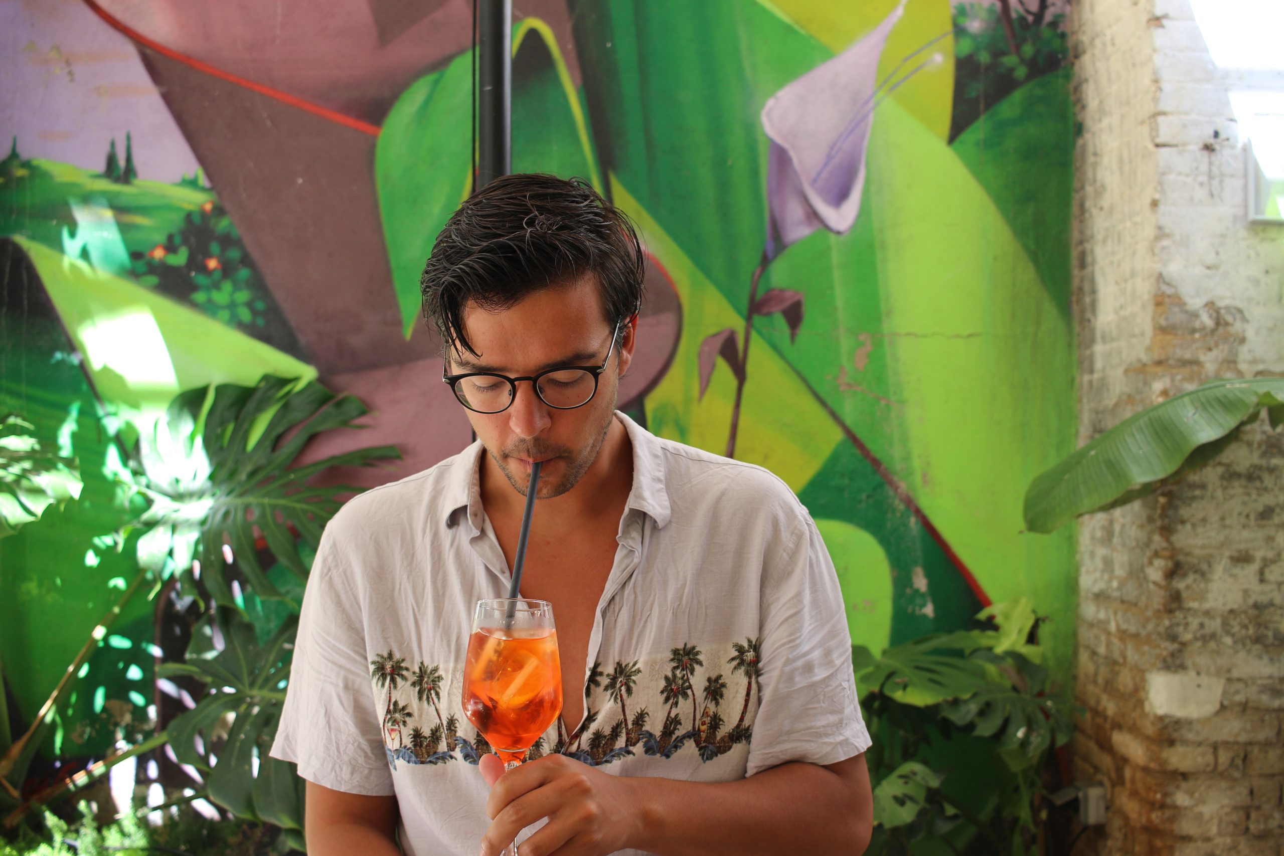 guy sipping on an aperol spritz